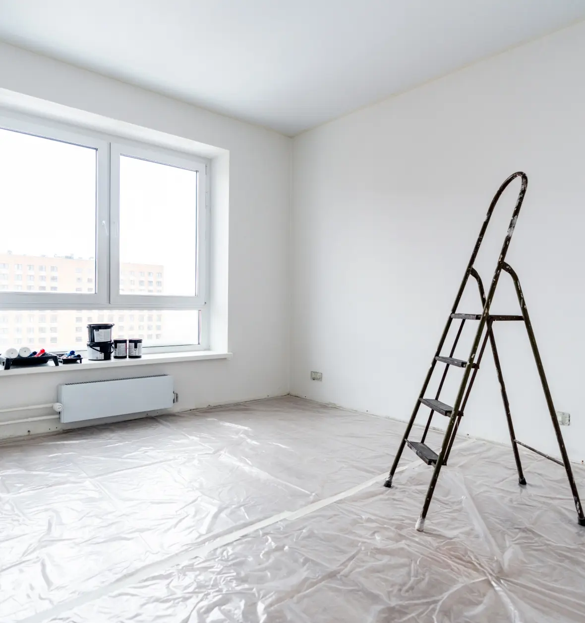 Group 8 (8) (10) Empty room with ladder and plastic sheets.